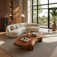 Freeform coffee table with thick solid wood top and low curved base for modern rooms