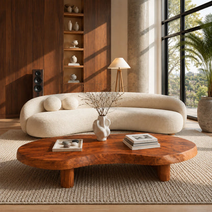 Sculptural coffee table with flowing top edges and bold low base for contemporary rooms