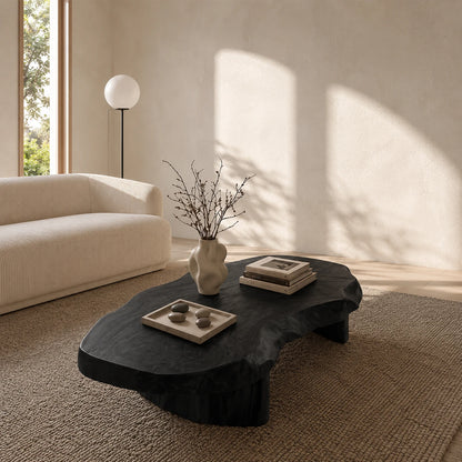Statement coffee table with natural curves and low pedestal legs for refined modern homes