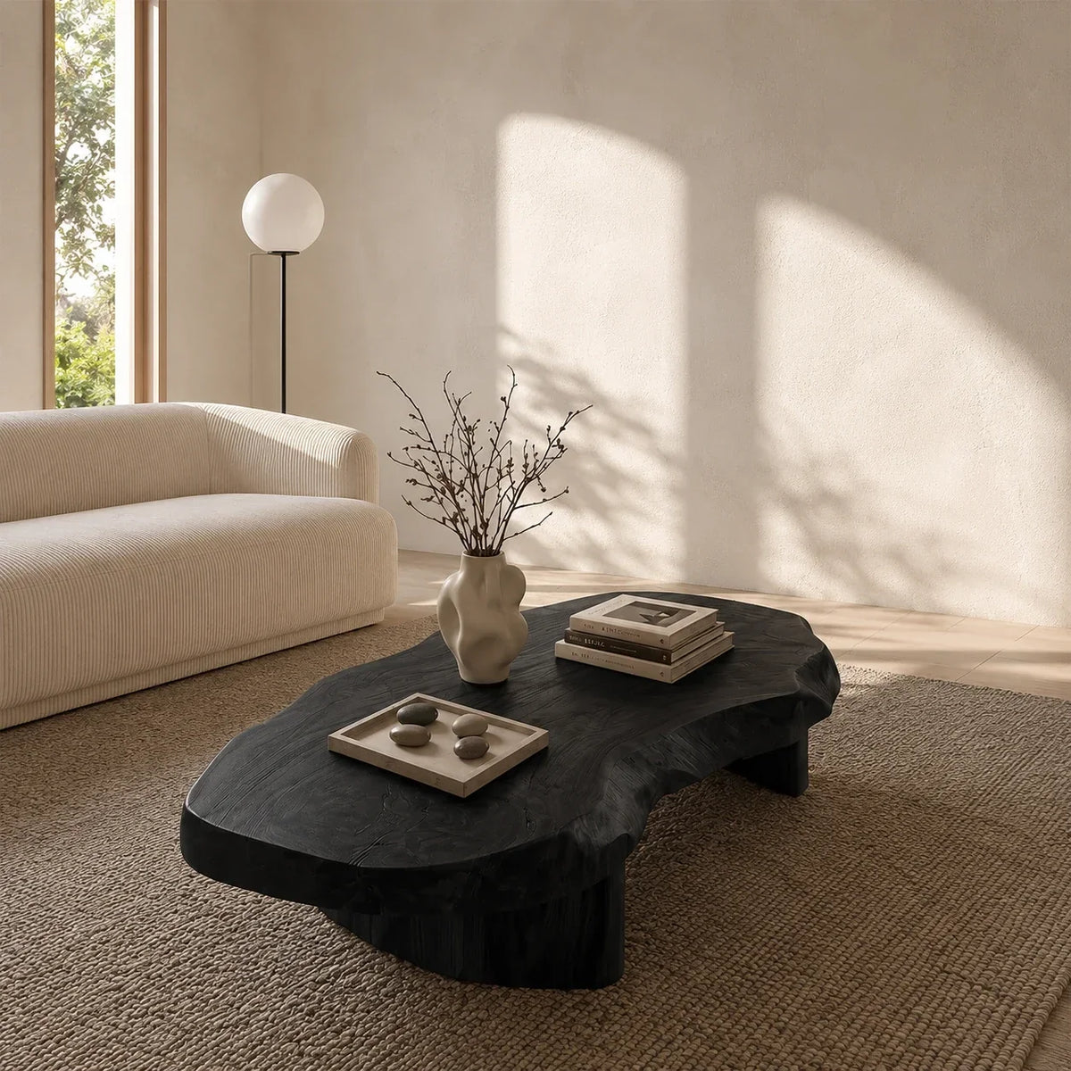 Statement coffee table with natural curves and low pedestal legs for refined modern homes