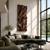 A tall decorative wall panel with carved contours brings texture to an airy living space