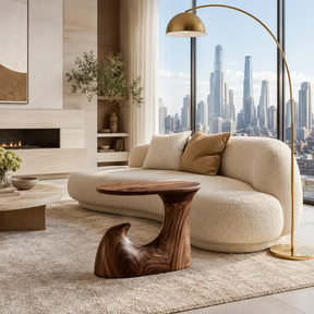 Organic modern side table styled beside curved seating in a refined city interior