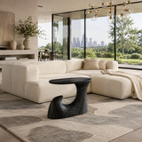 Luxury side table with a flowing pedestal base and compact top in a bright interior