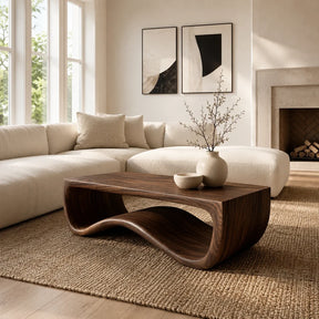 Sculptural coffee table with wave base and broad top in a refined modern living room