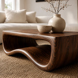Designer coffee table with artistic wave form and spacious surface in a bright interior