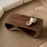Modern coffee table with smooth contours and sculptural support in a serene home space