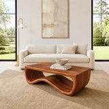 Curved coffee table adds visual movement and practical surface to a minimalist interior