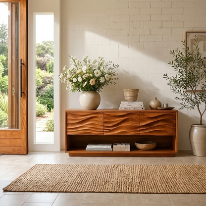 Contemporary entryway console featuring carved wave panels and spacious lower display shelf