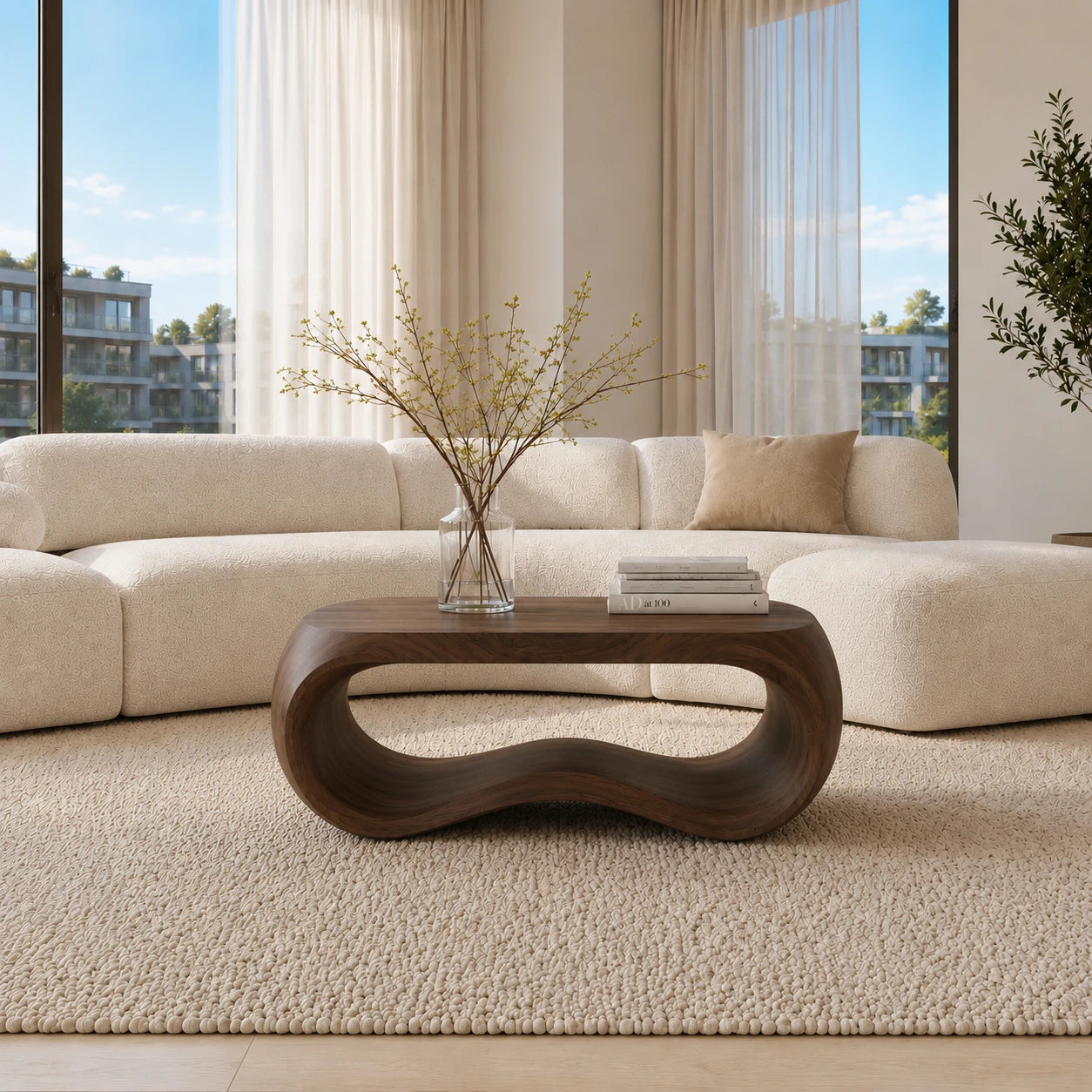 Living room coffee table with curved sculptural base and broad handcrafted wood surface