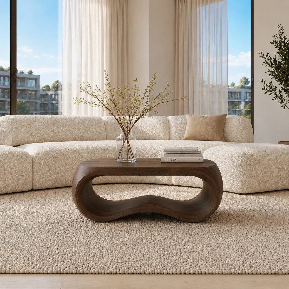 Living room coffee table with curved sculptural base and broad handcrafted wood surface