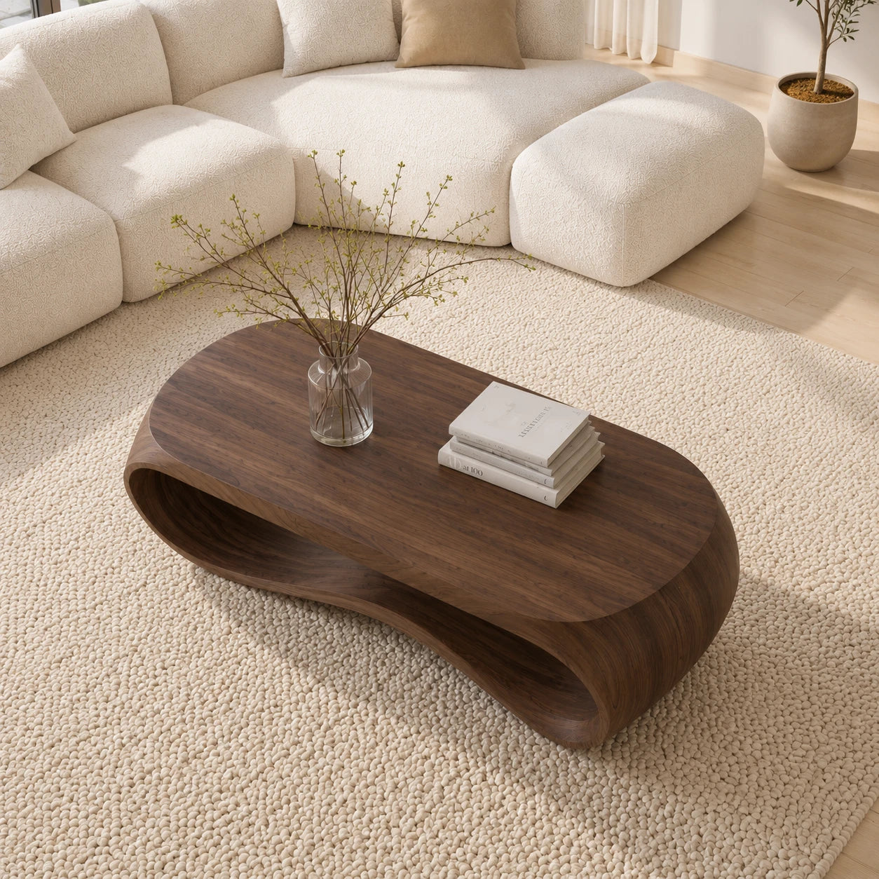 Designer coffee table with fluid silhouette and open base for contemporary living spaces