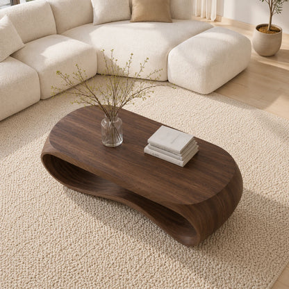 Designer coffee table with fluid silhouette and open base for contemporary living spaces